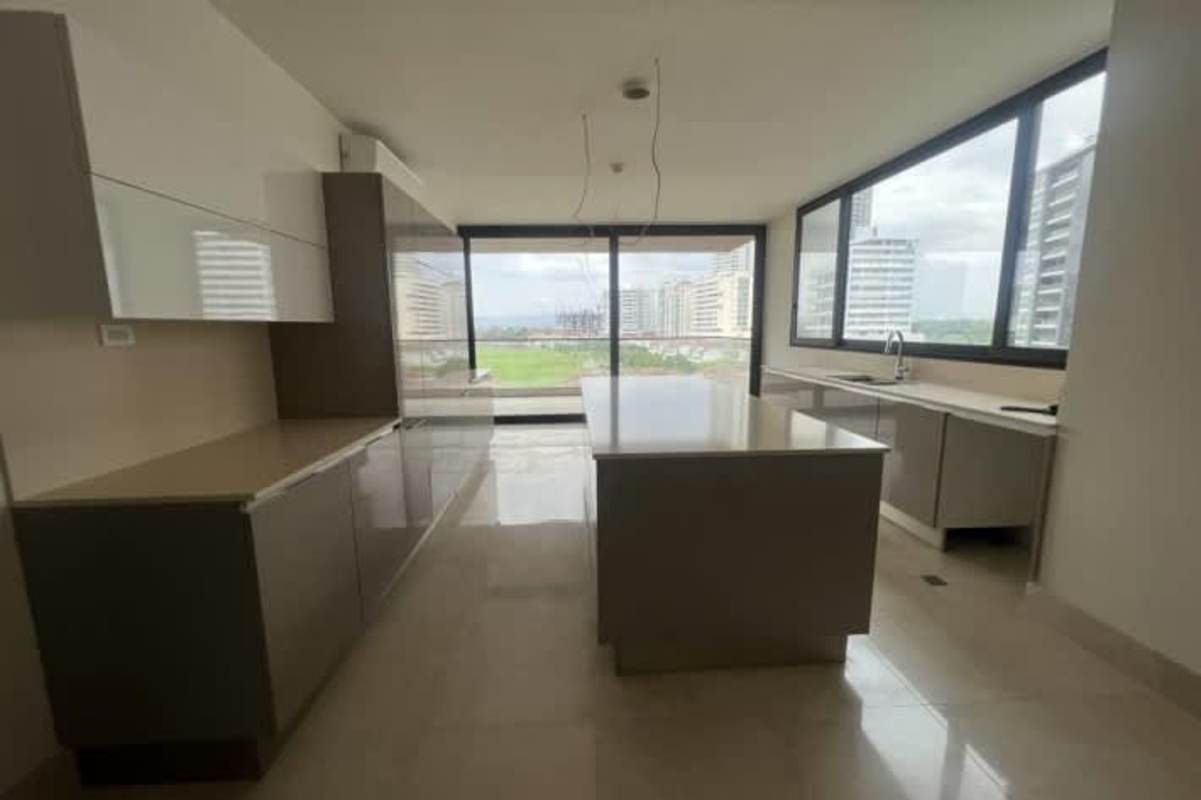 Spacious luxury kitchen with large windows, island design and view of golf course in Panama