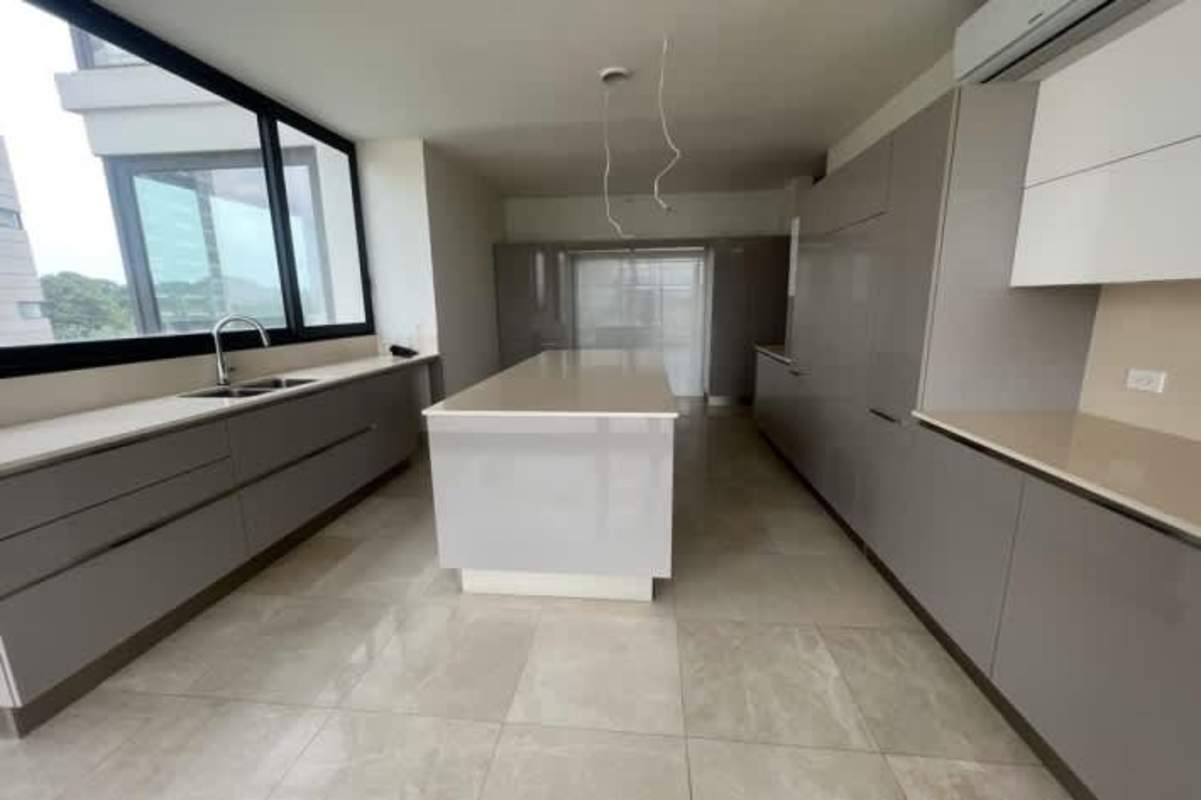 Bright modern kitchen space with island, panoramic window and tile floors at Santa María Panama