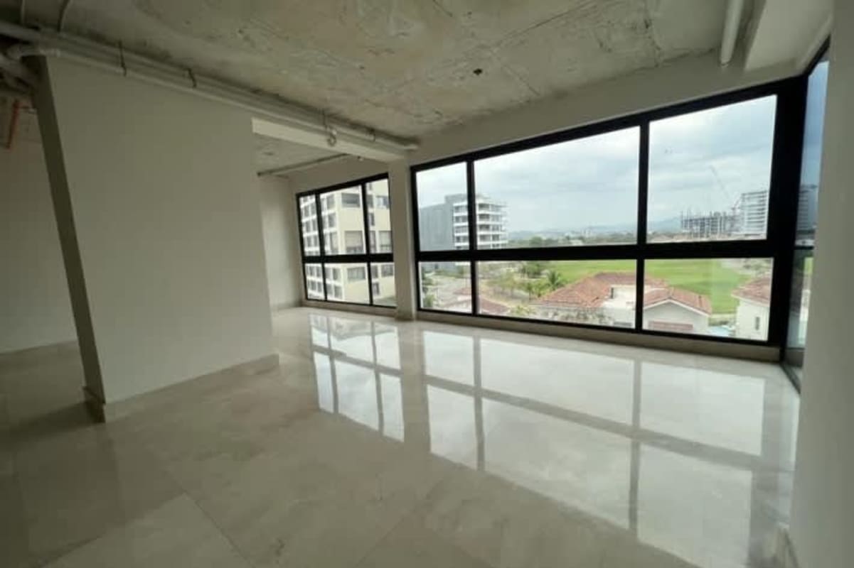 Spacious empty living room with corner panoramic windows and marble floors in Santa María Panama
