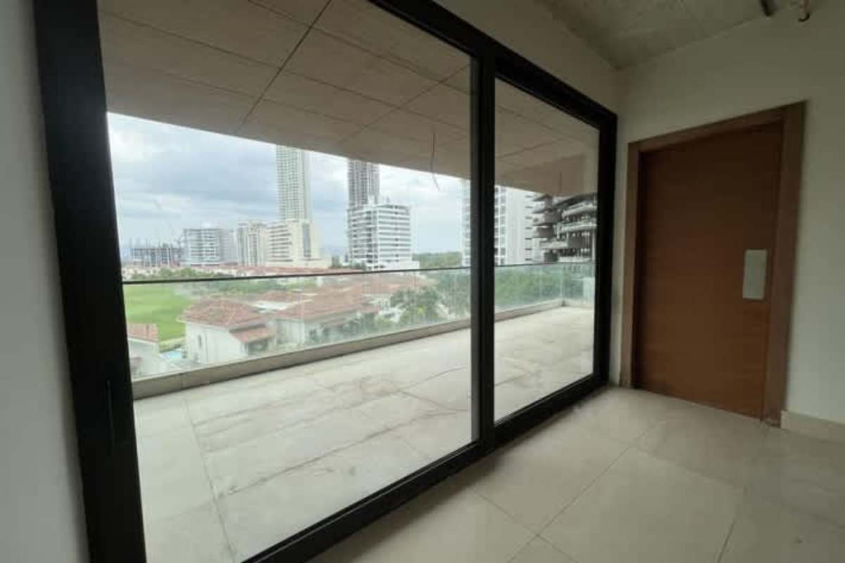 Modern open interior with large glass doors to terrace overlooking golf and skyline