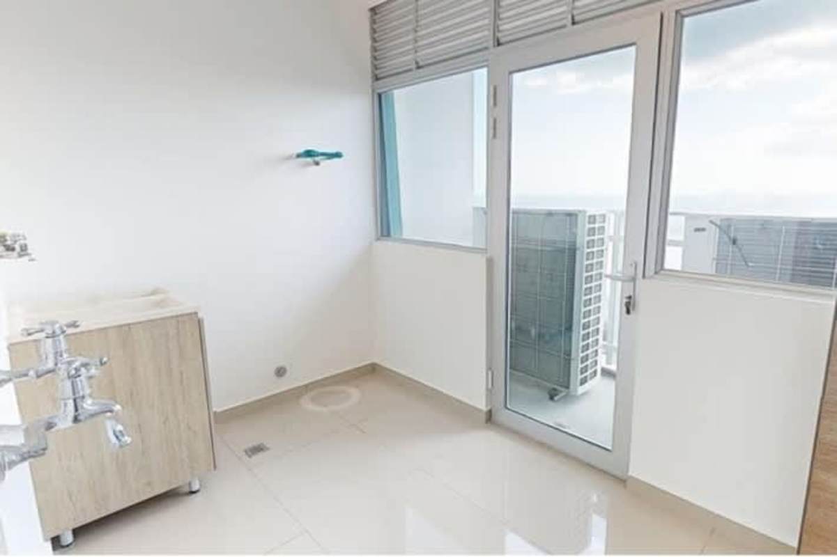 Open living area with large windows, ocean views, and modern furniture at Smartxy Diamond Tower in Costa del Este