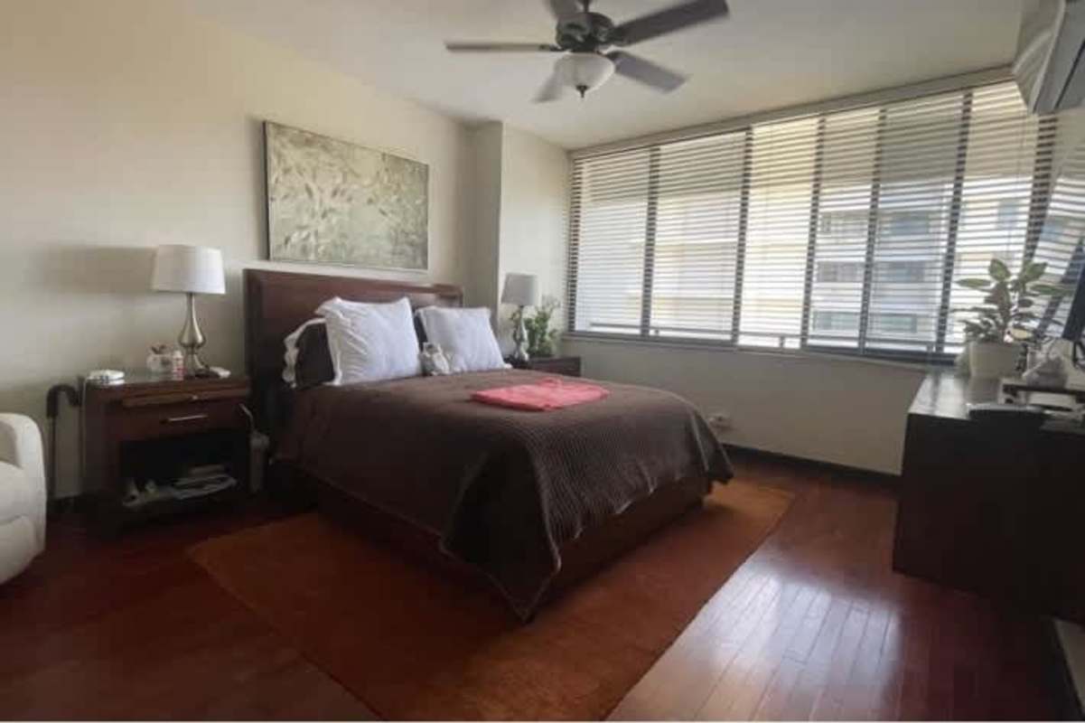 Bright bedroom with hardwood floors, walk-in closet and en-suite bath in Bella Vista Panama