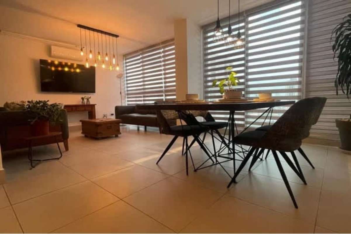 Open living dining room with large windows city views PH Obarrio Tower Panama