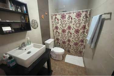 Modern bathroom with vessel sink shelving toilet glass mirror PH Villa Brisas Coronado Panama
