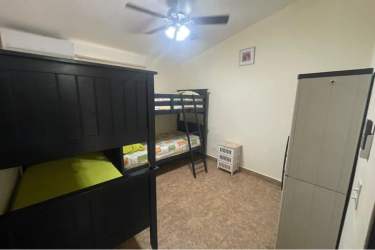 Bedroom with bunk bed tile floor wardrobe ceiling fan at PH Villa Brisas Coronado Panama