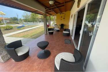 Outdoor terrace with ceiling fan wicker seating garden view PH Villa Brisas de Lajas Coronado Panama