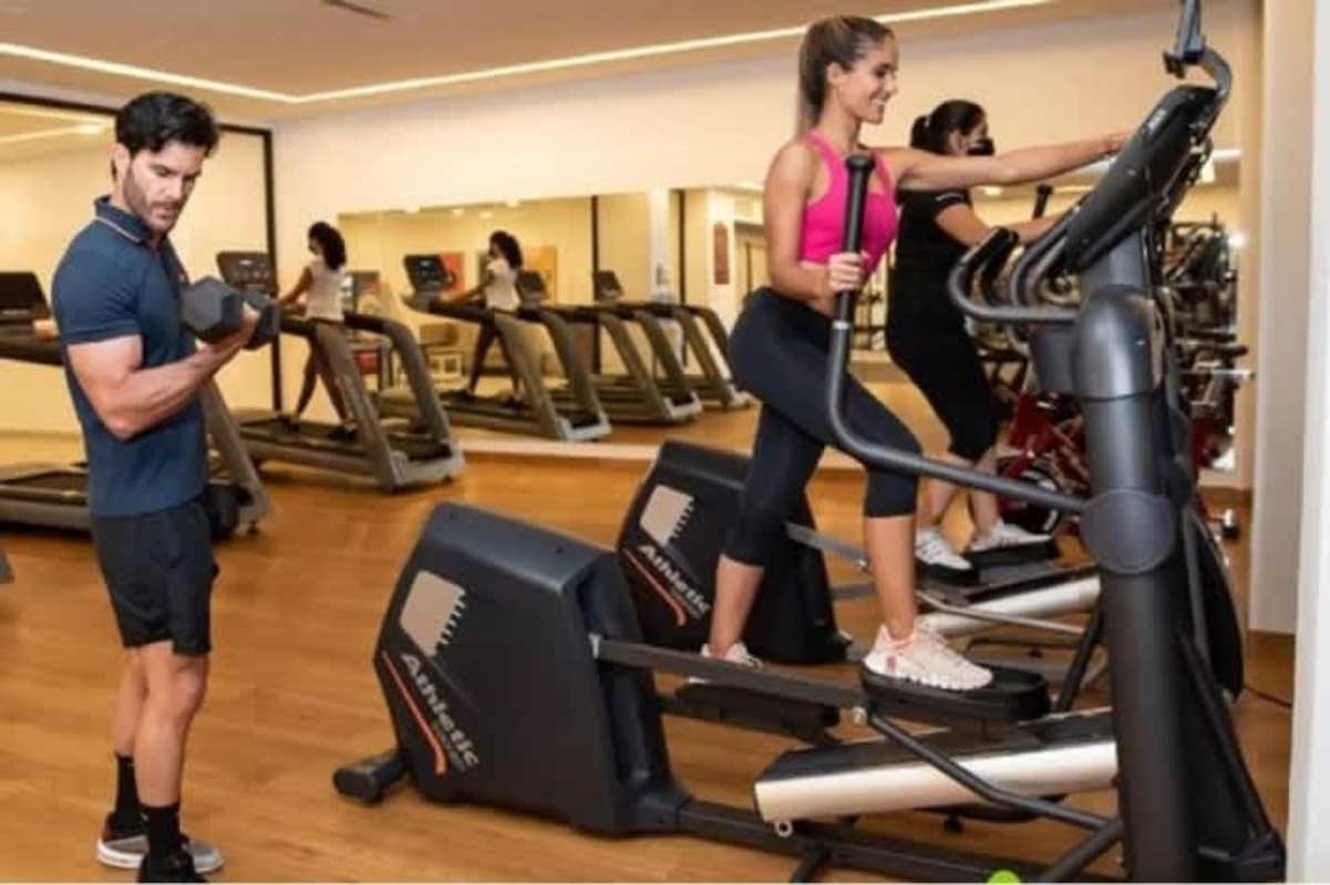 Apartment complex gym with modern equipment mirror wall treadmills Sky Park Condado del Rey Panama