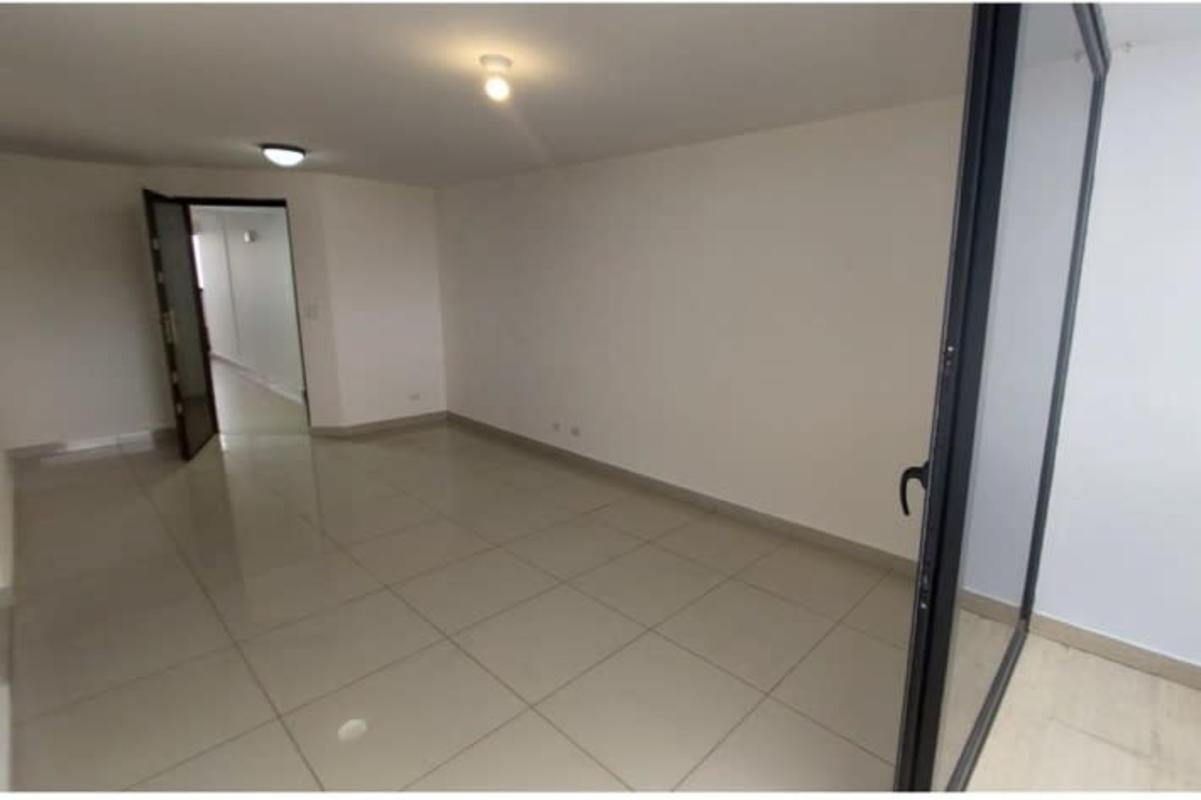 Apartment kitchen with granite counters, wooden cabinets, double sink, and gas stove in Condado Country Club Panama