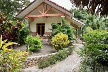 Open concept kitchen and living space with tile flooring and wood cabinetry in oceanfront home Panama