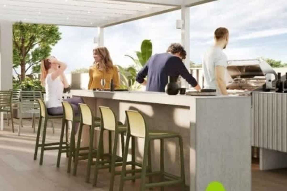 Modern outdoor kitchen and BBQ pergola area at PH Altamira Gardens with seating and greenery Condado del Rey Panama City