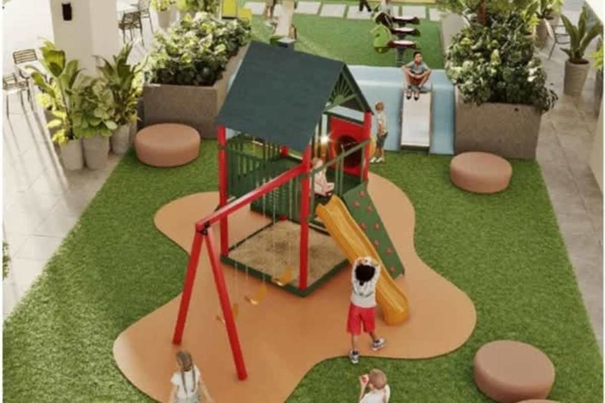 Children's outdoor playground with slide, swing, sandbox, artificial grass at Altamira Gardens Panama City