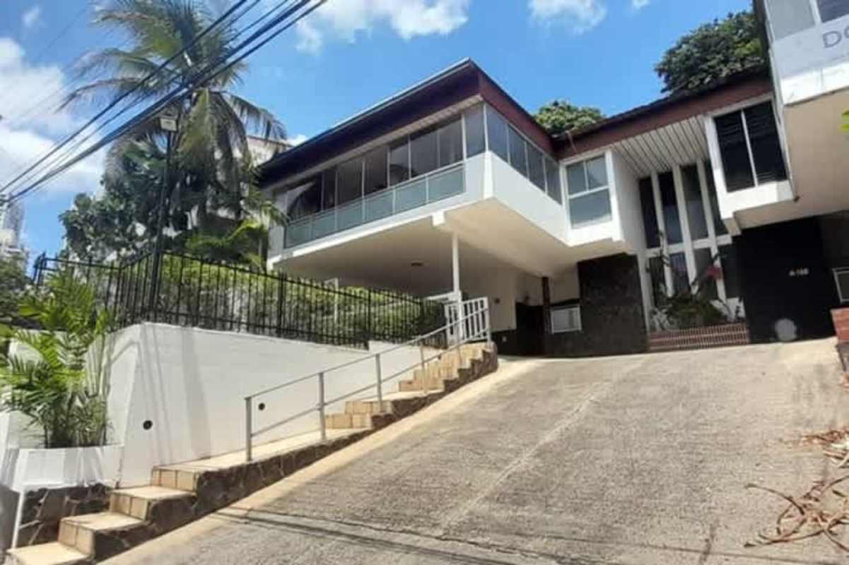 Modern multi-story house exterior with balconies, large windows, and garage parking Betania Panama