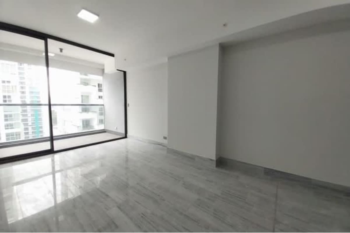 Modern bedroom with large windows overlooking city in Nuovo Residences Marbella Panama