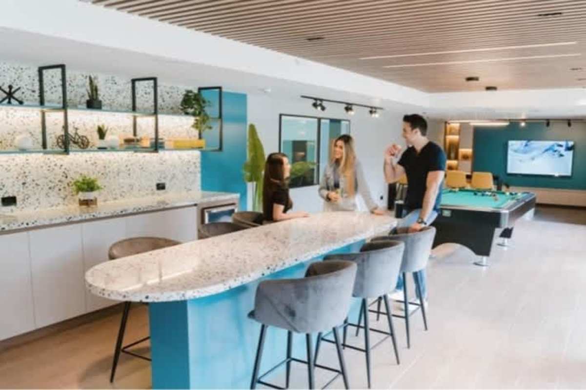 Indoor community lounge area with kitchenette, pool table, seating at Albrook Residences Panama