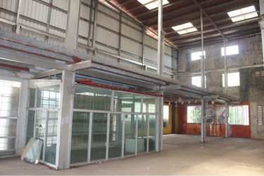 Expansive empty warehouse interior with steel beams high roof and ventilation blocks in Aguadulce Panama