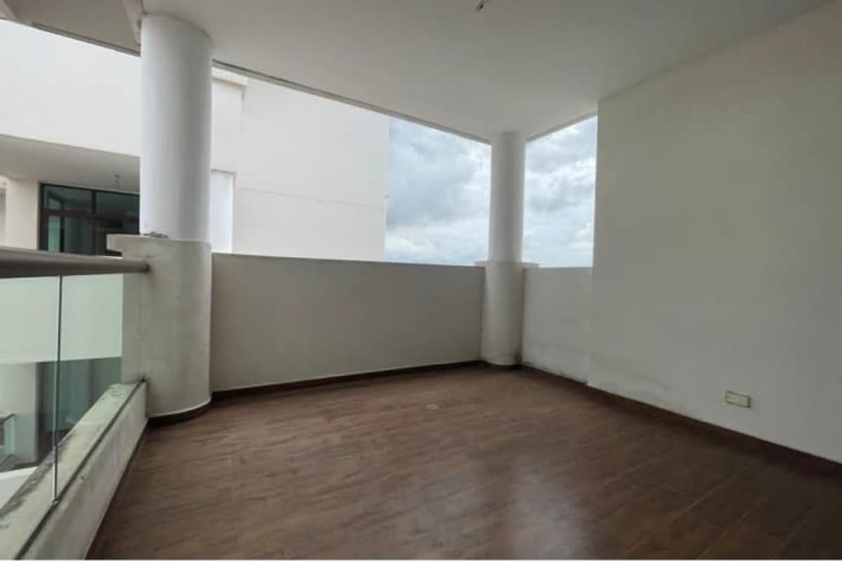 Modern balcony with glass railing overlooking green areas at Costa Sur Club Residences Panama