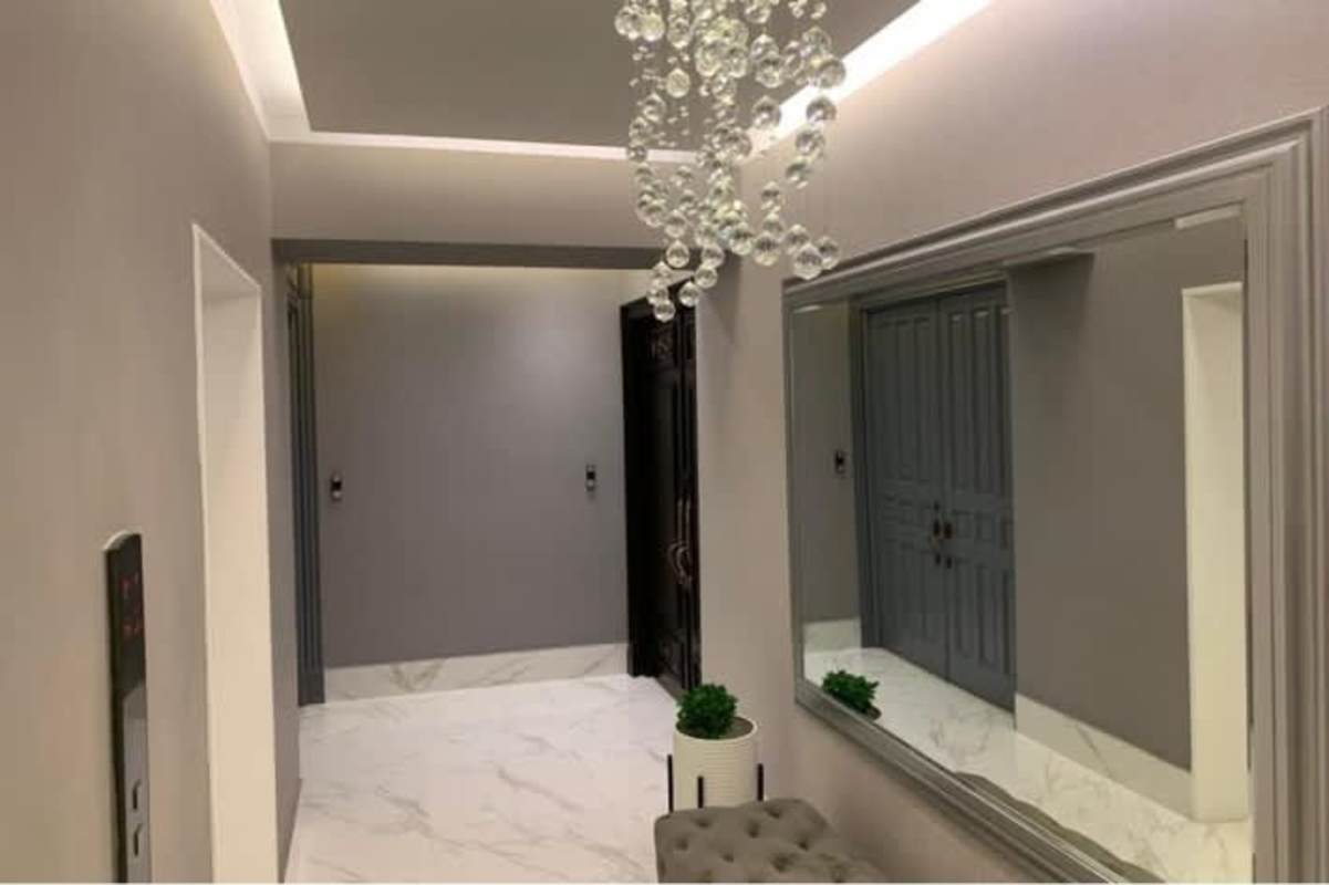 Modern bathroom with double vanity, glass shower, marble finishes at PH Golden Palace Paitilla