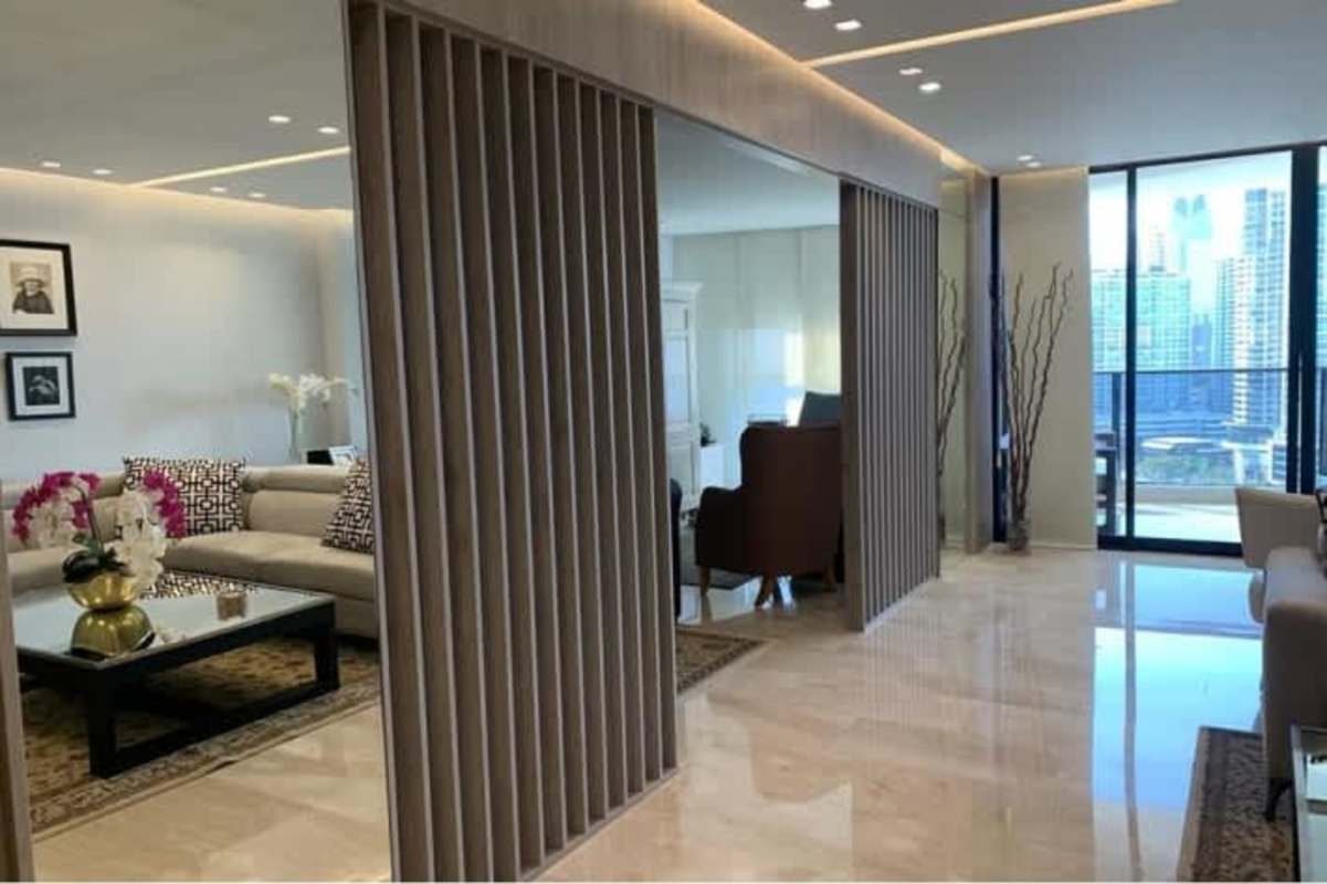 Contemporary hallway with marble floors, chandelier, wall mirror at luxury PH Golden Palace Panama