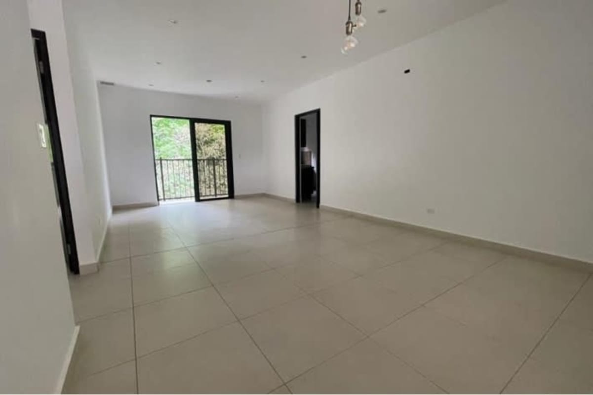 Large minimalist living room with neutral tile floors, sliding doors to balcony in PH Albrook Gardens