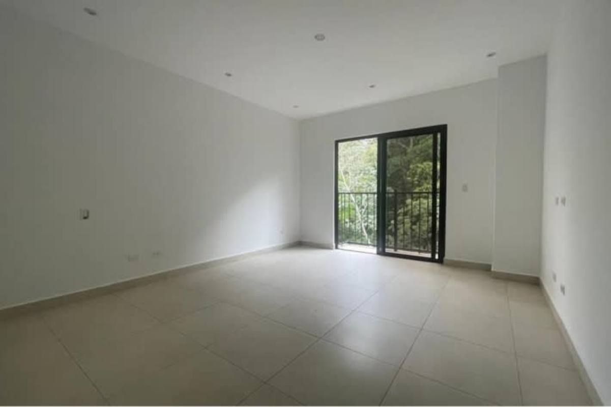 Modern apartment open living room with sliding door to balcony forest view Panama City
