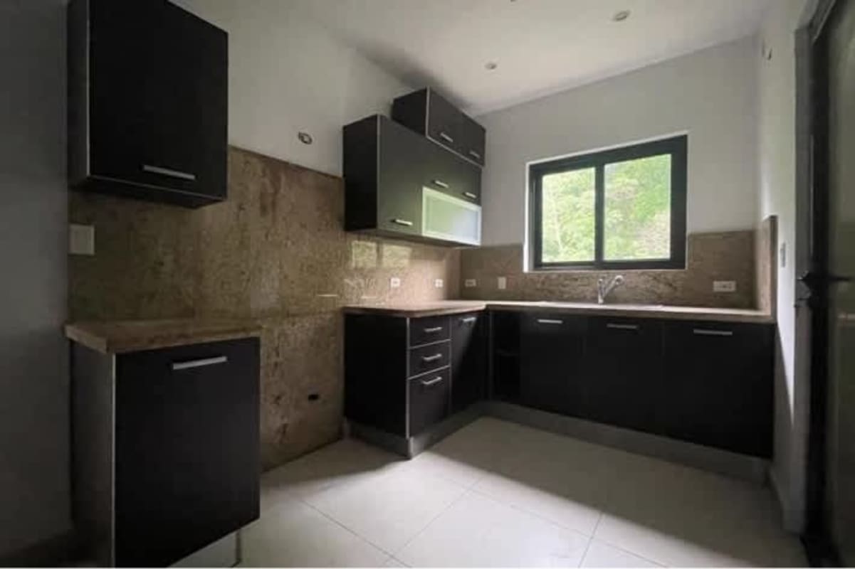 Contemporary kitchen with granite countertops dark wood cabinetry in PH Albrook Gardens