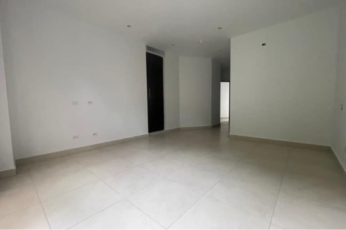 Large empty living space white walls tile floors and balcony in Albrook Gardens apartment
