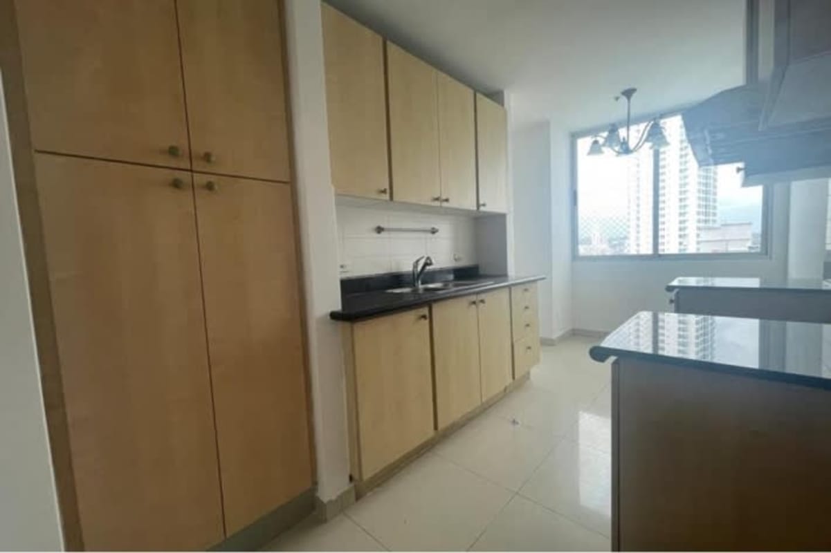 Open kitchen with wood cabinetry and granite countertops in PH Costa del Mar Panama