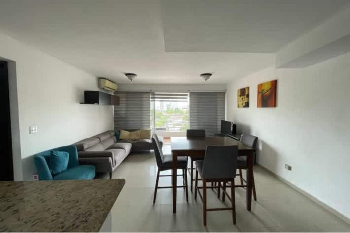 Spacious living and dining area with tiled floors and large windows in Villa Medici Panama apartment