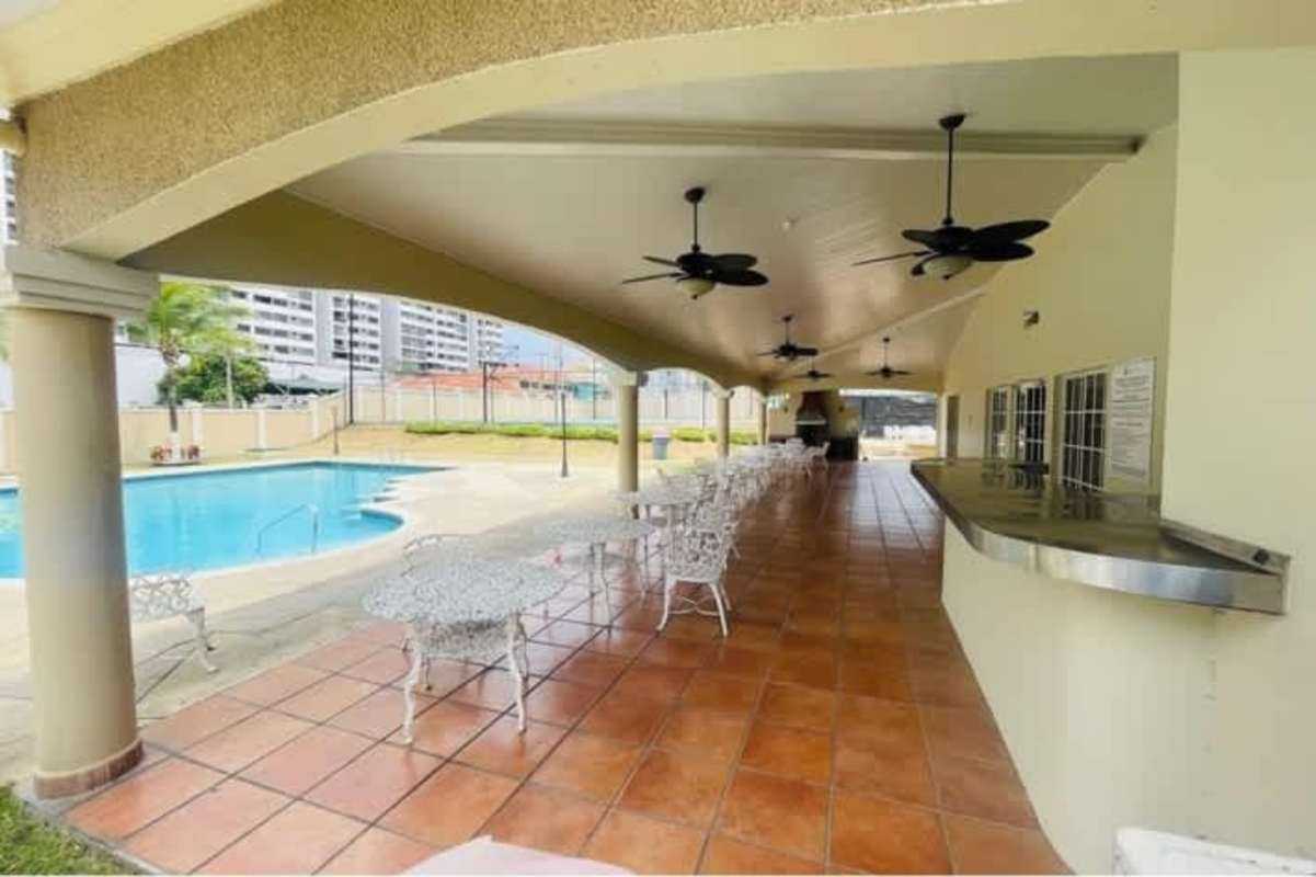 Spacious living room with arched windows, tile floor, ceiling fixtures in house for rent Condado del Rey Panama