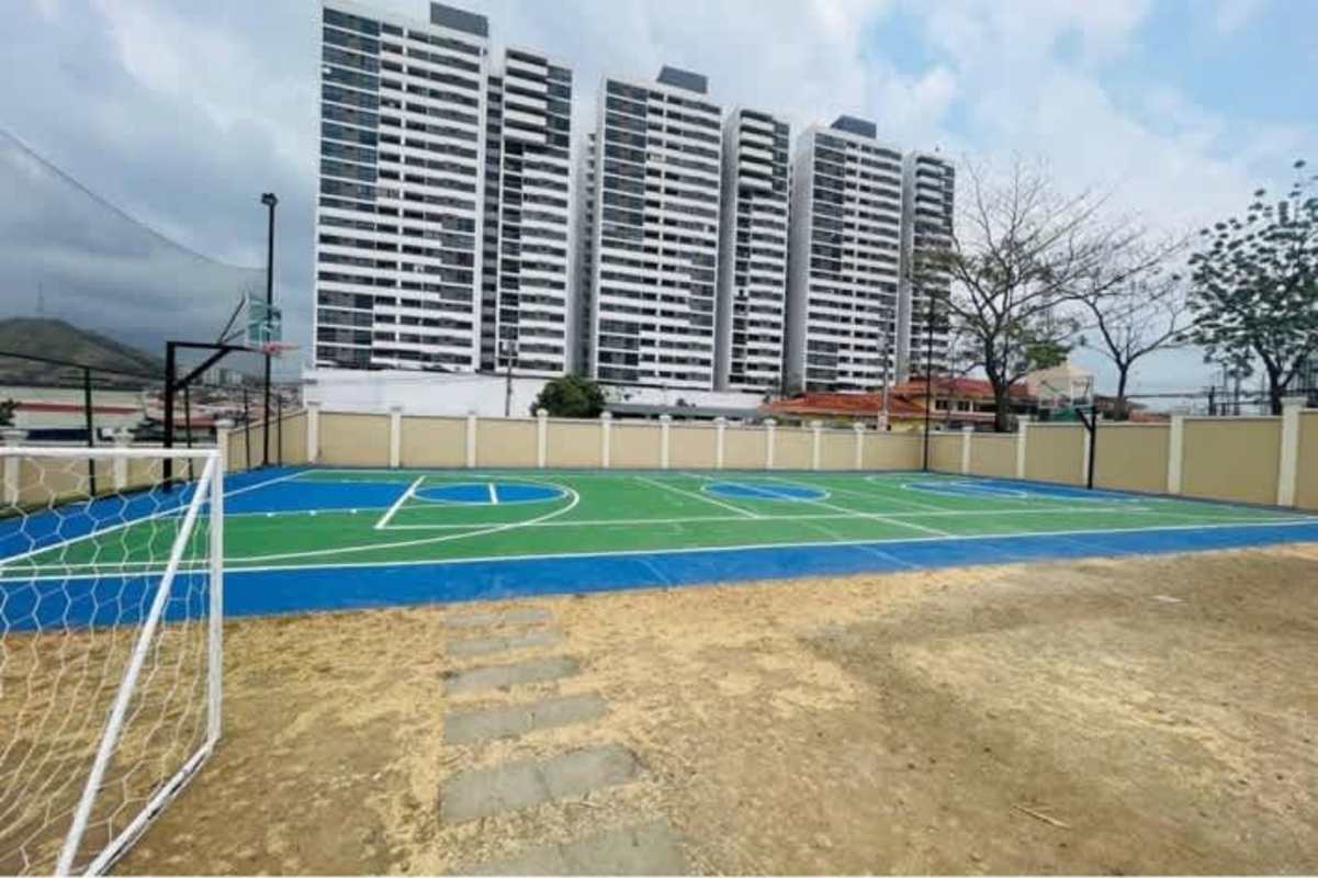 Swimming pool surrounded by deck and palm trees in Condado del Rey house community Panama