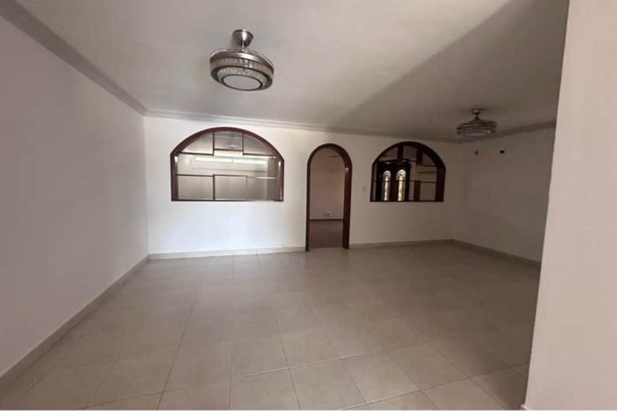 Living area with tiled floors, arched windows, modern ceiling lights rent Condado del Rey Panama