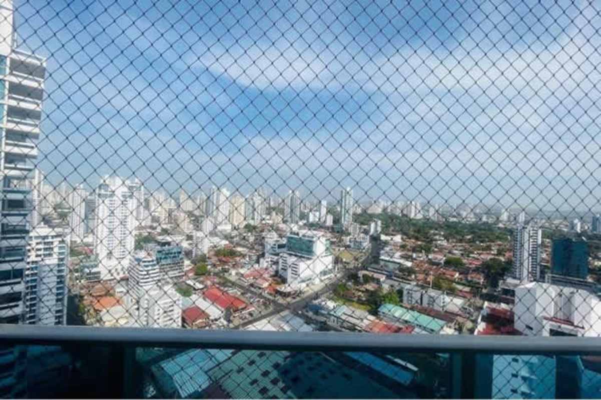 Bright bedroom with floor-to-ceiling window, AC and city view at PH Titanium Panama