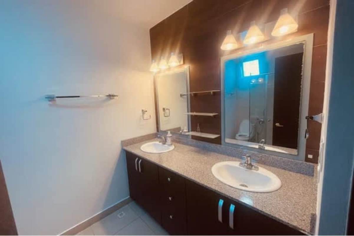 Modern bathroom with glass enclosed shower and granite countertop at PH Titanium Panama