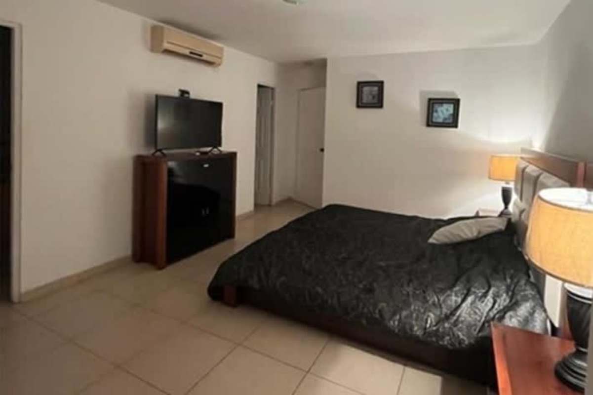 Furnished bedroom with large window, closet, and ocean skyline views PH Parque del Mar Costa del Este Panama