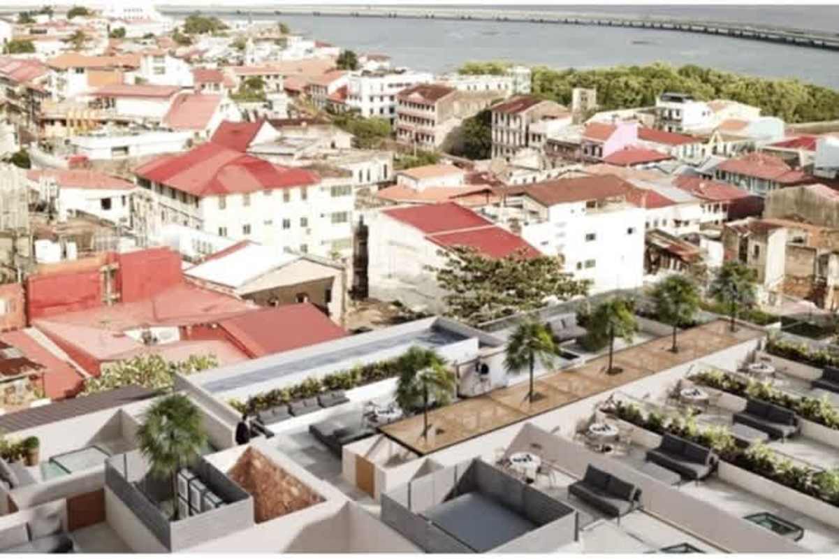 Contemporary rooftop with outdoor lounge spaces, palm trees and panoramic ocean view in Casco Viejo Panama