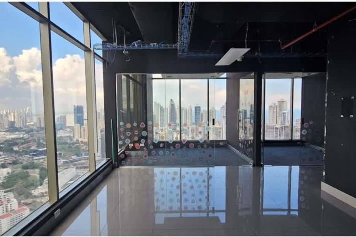 Modern empty office with floor to ceiling windows offering city and water views BICSA Tower Panama