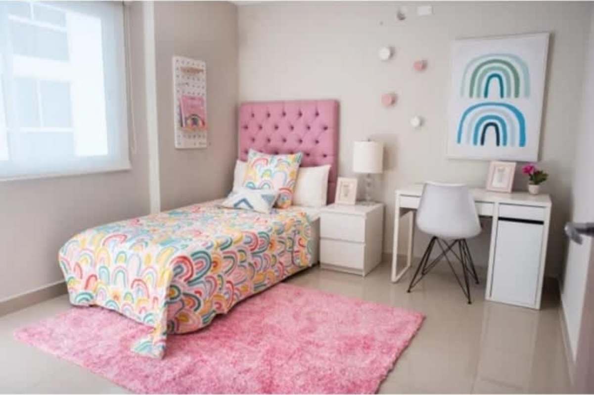 Children's bedroom with colorful rainbow decor and bright window light in PH Villa las Fuentes Panama