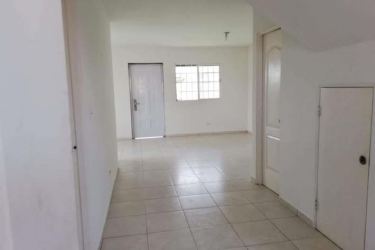 Entry hall with tiled floor and under staircase storage in duplex Costa Verde