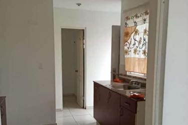Kitchen with wood cabinets and tile floor at duplex Costa Verde La Chorrera Panama