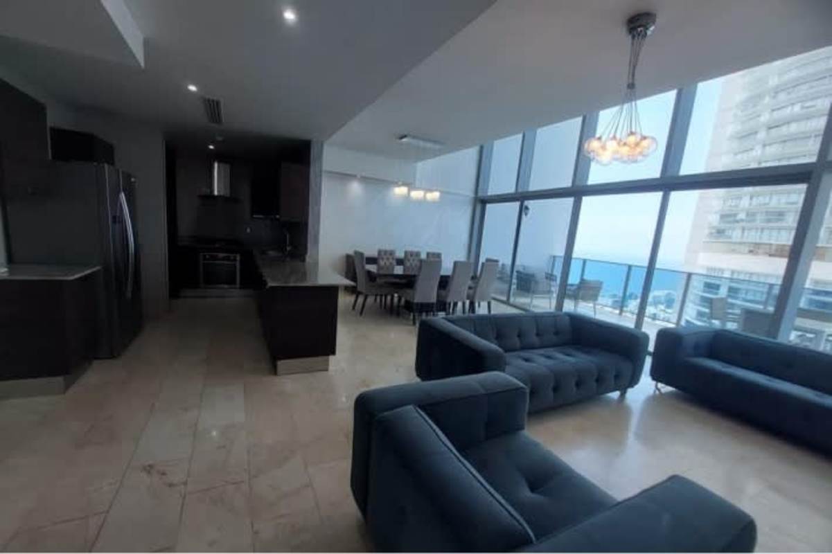 Open kitchen with granite counters and dining space facing city skyline Grand Tower Punta Pacifica Panama