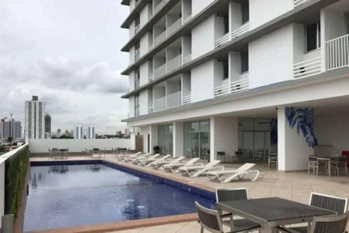 Modern rooftop pool with sun loungers and skyline view in PH Alegría Panama City