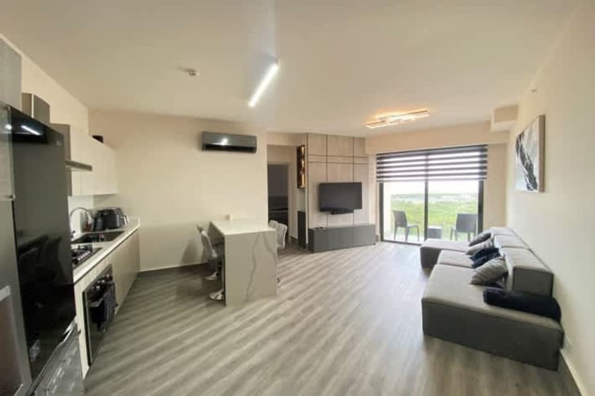 Open plan kitchen and living room with modern finishes at PH Ocean House