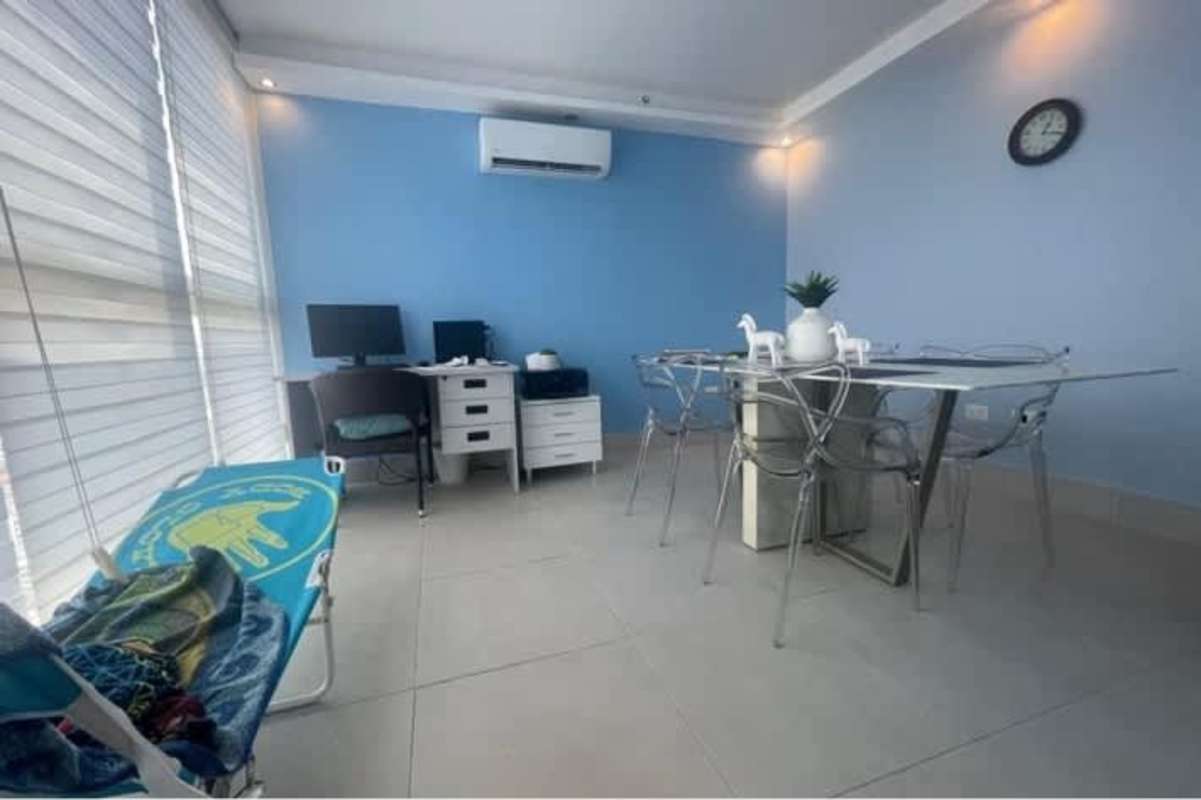 Office or study room with large windows blue accent wall PH Marble Tower Obarrio Panama