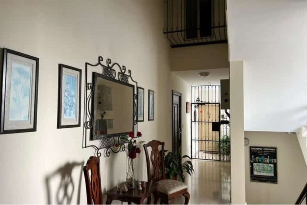 Kitchen with wooden cabinets, stove, refrigerator at PH Bahia Azul Via Porras Panama City