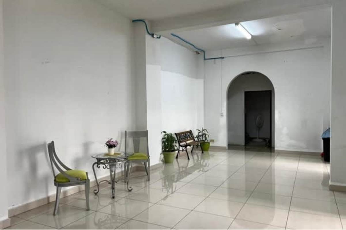 Dining room with city skyline view, large windows and chandelier at PH Bahia Azul Via Porras Panama City