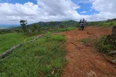 Stream with lush green hills on agricultural land in Chiriquí near Volcán