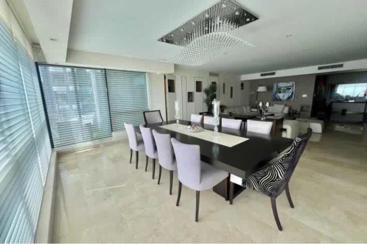 Contemporary dining room with large window and skyline views at PH Miramar Plaza Avenida Balboa Panama City