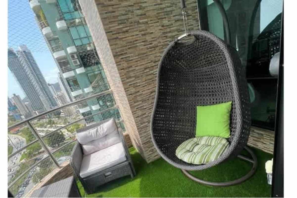 Spacious balcony with outdoor seating, glass railings overlooking Pacific Ocean and skyline from PH Miramar Plaza Panama