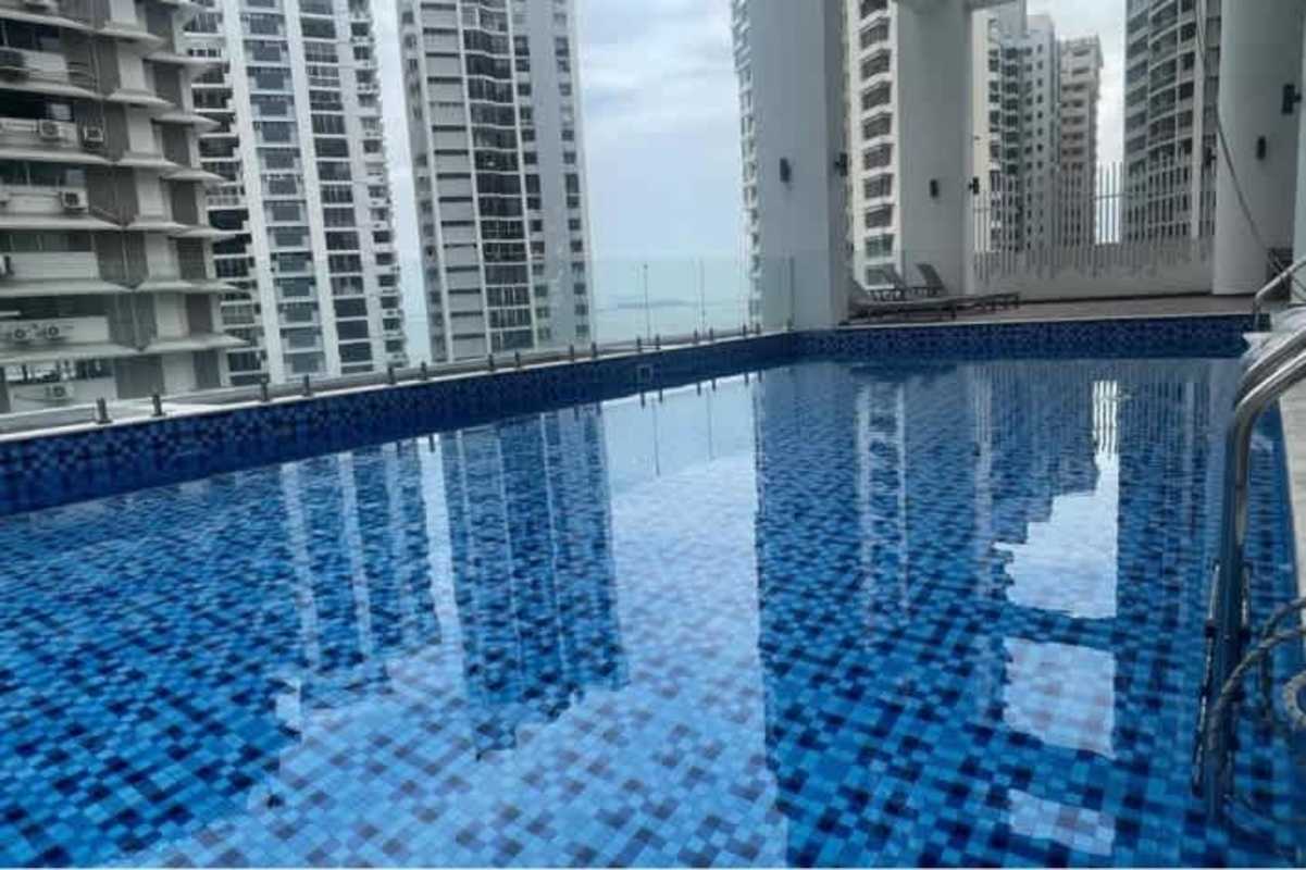 Circular jacuzzi next to infinity swimming pool city skyline PH Pacific View Panama City