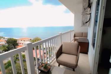 Bright living room with sliding glass doors to ocean view balcony PH Ibiza San Carlos Panama